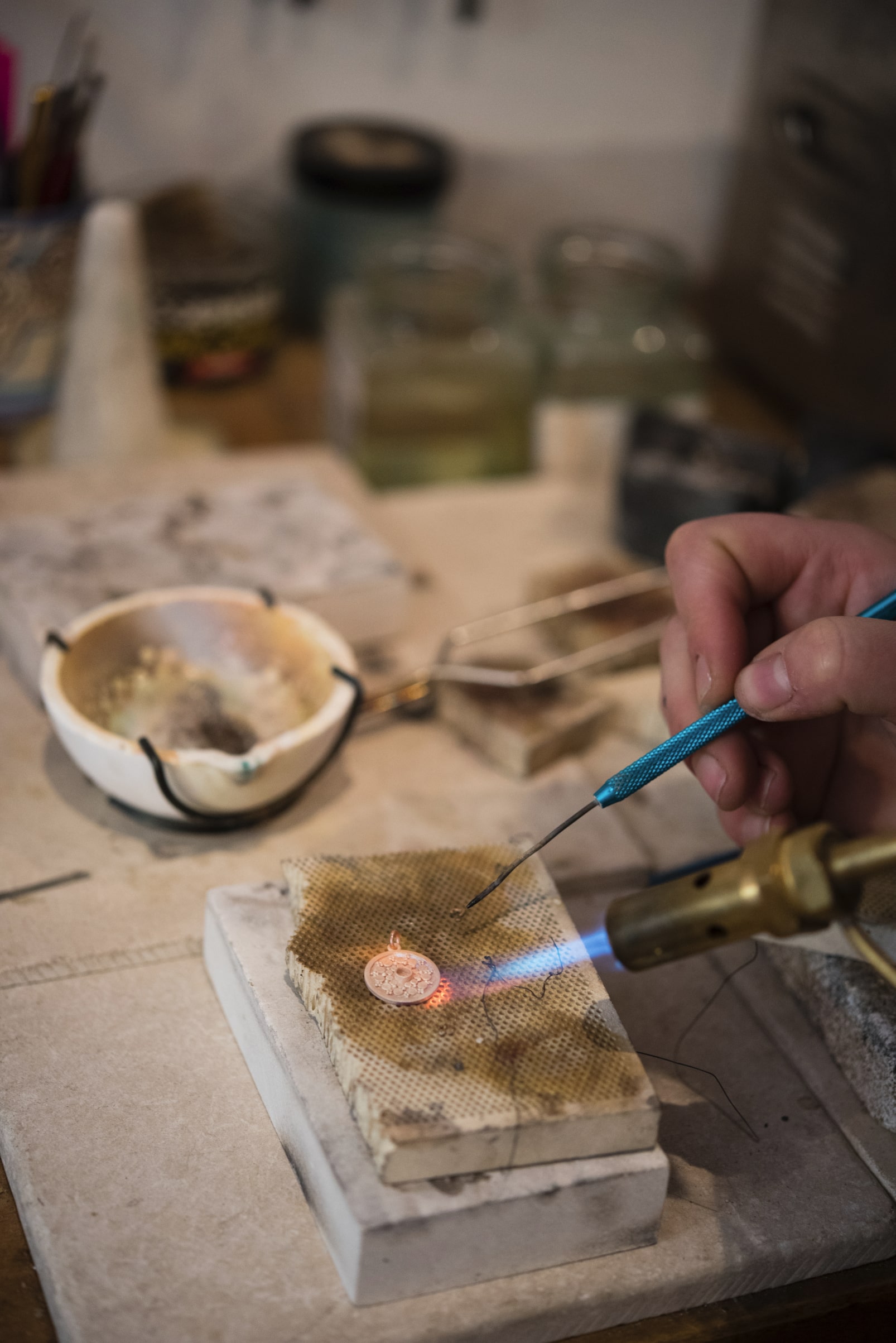 a medallion being heated with a blow touch