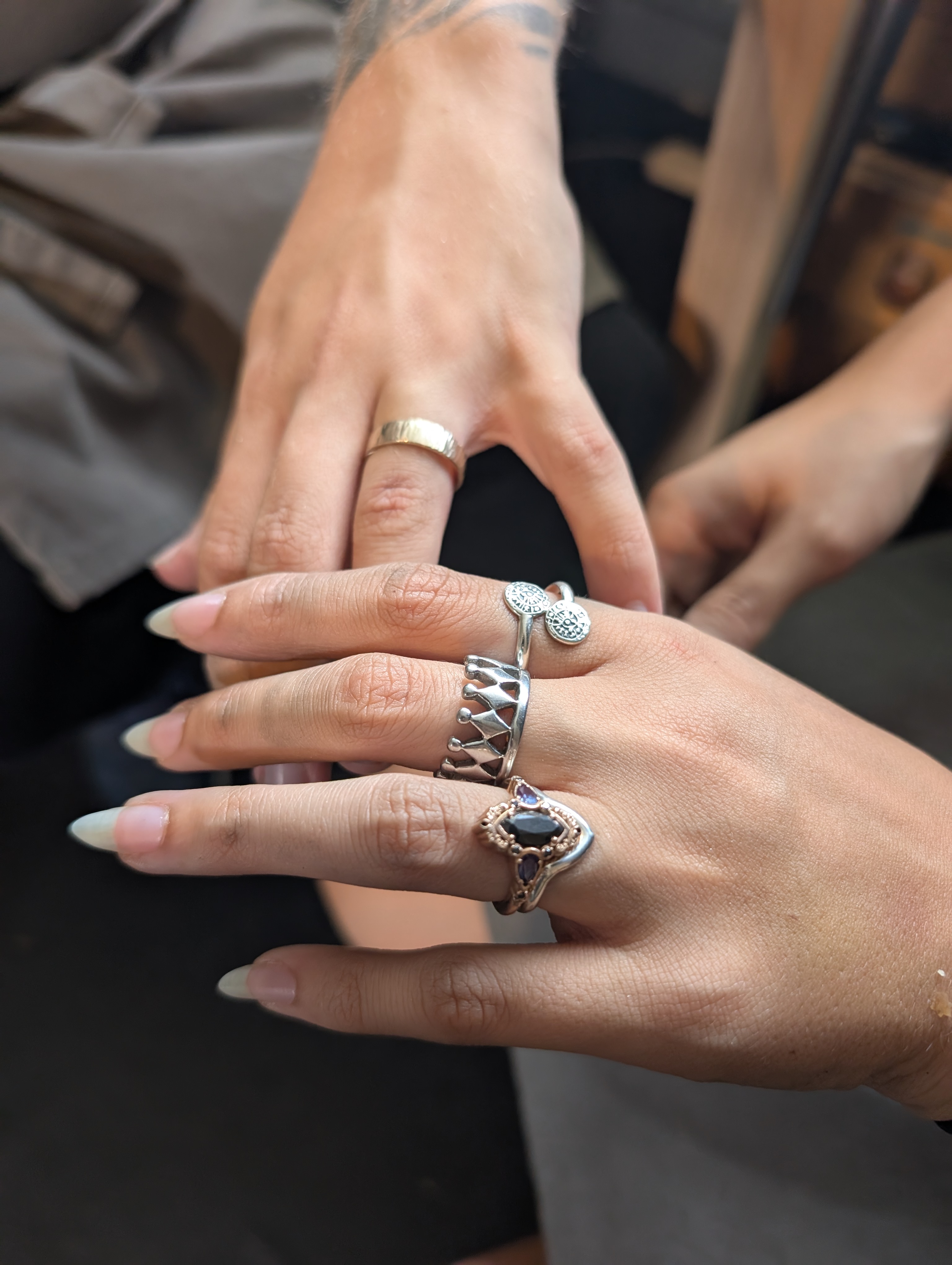 a couple's hands showing their gothic wedding rings